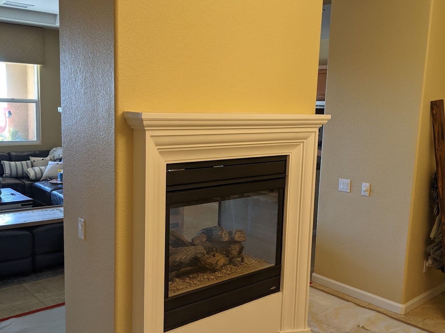 Before: plain painted fireplace column with a small white wood surround